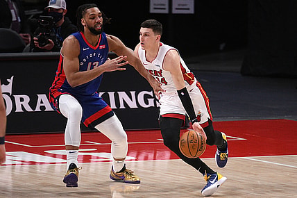 May 16, 2021; Detroit, Michigan, USA; Miami Heat guard Tyler Herro (14) drives to the basket as Detroit Pistons center Jahlil Okafor (13) defends during the first quarter at Little Caesars Arena. Mandatory Credit: Tim Fuller-USA TODAY Sports