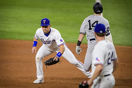 May 17, 2021; Arlington, Texas, USA; Texas Rangers first baseman Nate Lowe (30) puts out New York Yankees shortstop Tyler Wade (14) on a throw from starting pitcher Jordan Lyles (24) during the fifth inning at Globe Life Field. Mandatory Credit: Jerome Miron-USA TODAY Sports
