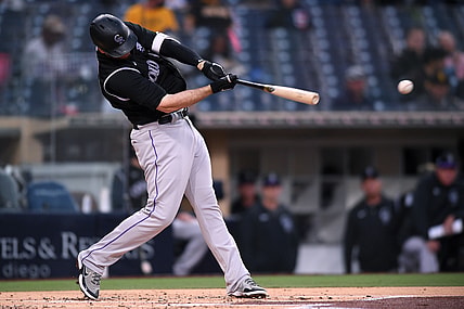 May 18, 2021; San Diego, California, USA; Colorado Rockies first baseman CJ Cron (25) singles against the San Diego Padres during the second inning at Petco Park. Mandatory Credit: Orlando Ramirez-USA TODAY Sports