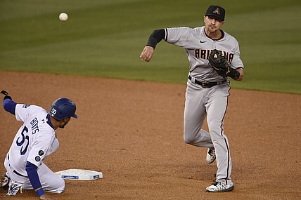 May 18, 2021; Los Angeles, California, USA; Arizona Diamondbacks shortstop Nick Ahmed (13) throws to first after forcing out Los Angeles Dodgers center fielder Mookie Betts (50) at second base during the third inning at Dodger Stadium. Mandatory Credit: Kelvin Kuo-USA TODAY Sports