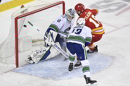 May 19, 2021; Calgary, Alberta, CAN; Calgary Flames forward Matthew Tkachuk (19) scores on Vancouver Canucks goalie Braden Holtby (49) during the first period at Scotiabank Saddledome. Mandatory Credit: Candice Ward-USA TODAY Sports