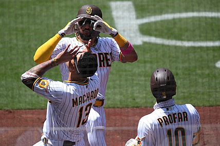 May 19, 2021; San Diego, California, USA; San Diego Padres shortstop Fernando Tatis Jr. (top) celebrates with  third baseman Manny Machado (13) after hitting a home run against the Colorado Rockies during the fourth inning at Petco Park. Mandatory Credit: Orlando Ramirez-USA TODAY Sports