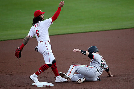 Cincinnati Reds second baseman Jonathan India (6) follows through on an errant throw to first as San Francisco Giants catcher Buster Posey (28) slides into second base on an attempted double play in the first inning during a baseball game against the San Francisco Giants, Wednesday, May 19, 2021, at Great American Ball Park in Cincinnati.

San Francisco Giants At Cincinnati Reds May 19