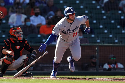May 22, 2021; San Francisco, California, USA; Los Angeles Dodgers second baseman Max Muncy (13) hits a single during the fourth inning against the San Francisco Giants at Oracle Park. Mandatory Credit: Darren Yamashita-USA TODAY Sports