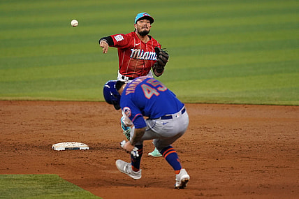 May 23, 2021; Miami, Florida, USA; Miami Marlins shortstop Miguel Rojas (19) gets the force out of New York Mets starting pitcher Jordan Yamamoto (45) while turning a double play in the 3rd inning at loanDepot park. Mandatory Credit: Jasen Vinlove-USA TODAY Sports