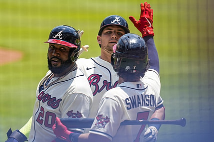 May 23, 2021; Cumberland, Georgia, USA; Atlanta Braves third baseman Austin Riley (27) (rear) reacts with left fielder Marcell Ozuna (20) and shortstop Dansby Swanson (7) after hitting a two run home run against the Pittsburgh Pirates during the first inning at Truist Park. Mandatory Credit: Dale Zanine-USA TODAY Sports