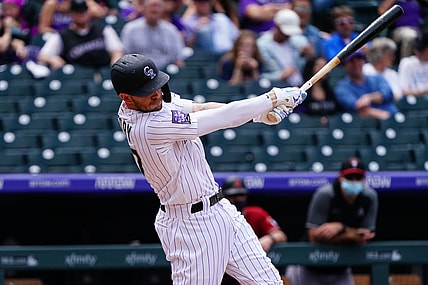 May 23, 2021; Denver, Colorado, USA; Colorado Rockies shortstop Trevor Story (27) RBI singles in the second inning against the against the Arizona Diamondbacks at Coors Field. Mandatory Credit: Ron Chenoy-USA TODAY Sports
