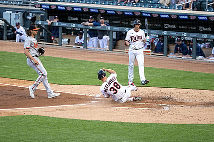 May 25, 2021; Minneapolis, Minnesota, USA; Minnesota Twins center fielder Rob Refsnyder (38) scores on a over thrown pitch by Baltimore Orioles starting pitcher Dean Kremer (64) during the second inning at Target Field. Mandatory Credit: Jordan Johnson-USA TODAY Sports