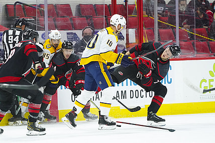 May 25, 2021; Raleigh, North Carolina, USA; Nashville Predators center Colton Sissons (10) checks Carolina Hurricanes left wing Steven Lorentz (78) during the first period in game five of the first round of the 2021 Stanley Cup Playoffs at PNC Arena. Mandatory Credit: James Guillory-USA TODAY Sports