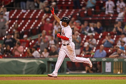 May 26, 2021; Boston, Massachusetts, USA; Boston Red Sox third baseman Rafael Devers (11) reacts after hitting a home run during the fourth inning against the Atlanta Braves at Fenway Park. Mandatory Credit: Paul Rutherford-USA TODAY Sports