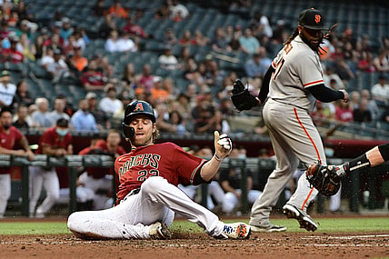 May 26, 2021; Phoenix, Arizona, USA; Arizona Diamondbacks right fielder Josh Reddick (22) scores as San Francisco Giants starting pitcher Johnny Cueto (47) looks on in the second inning at Chase Field. Mandatory Credit: Matt Kartozian-USA TODAY Sports