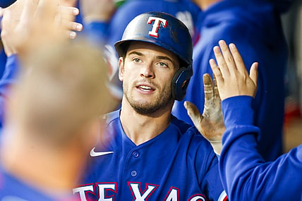 May 29, 2021; Seattle, Washington, USA; Texas Rangers second baseman Nick Solak (15) is greeted in the dugout after hitting an RBI-sacrifice fly against the Seattle Mariners during the fourth inning at T-Mobile Park. Mandatory Credit: Joe Nicholson-USA TODAY Sports