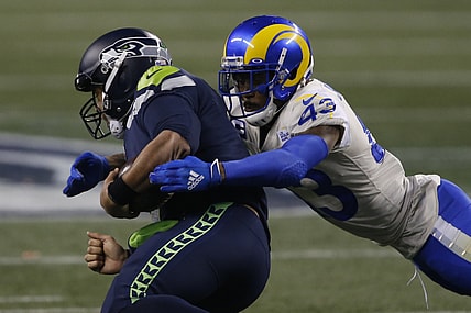 Jan 9, 2021; Seattle, Washington, USA; Los Angeles Rams safety John Johnson III (43) tackles Seattle Seahawks quarterback Russell Wilson (3) during the fourth quarter at Lumen Field. Mandatory Credit: Joe Nicholson-USA TODAY Sports