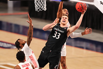 Mar 14, 2021; Fort Worth, TX, USA; Cincinnati Bearcats center Chris Vogt (33) shoots the ball against Houston Cougars forward Reggie Chaney (32) and guard DeJon Jarreau (3) during the second half at Dickies Arena. Mandatory Credit: Ben Ludeman-USA TODAY Sports