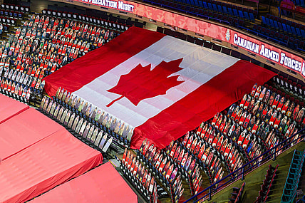 Mar 27, 2021; Calgary, Alberta, CAN; General view of cardboard cutouts of Canadian Armed Forces in front of the Canadian flag for the Canadian Armed Forces Appreciation Night prior to the game between the Calgary Flames and the Winnipeg Jets at Scotiabank Saddledome. Mandatory Credit: Sergei Belski-USA TODAY Sports