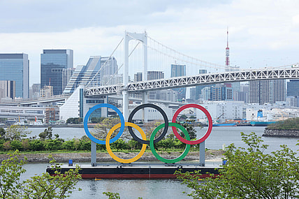 Apr 6, 2021; Tokyo, JAPAN; General view of the Olympic rings sculpture, Rainbow Bridge, and Tokyo Tower as seen from Odaiba in preparation for the Tokyo 2020 Olympic Summer Games set to begin in July 2021. Mandatory Credit: Yukihito Taguchi-USA TODAY Sports