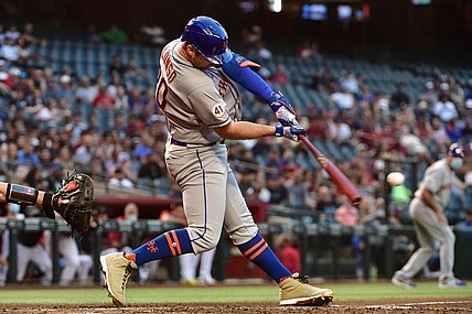 May 31, 2021; Phoenix, Arizona, USA; New York Mets first baseman Pete Alonso (20) hits a two-run RBI single in the third inning against the Arizona Diamondbacks at Chase Field. Mandatory Credit: Matt Kartozian-USA TODAY Sports