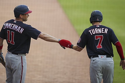 Jun 1, 2021; Atlanta, Georgia, USA; Washington Nationals shortstop Trea Turner (7) celebrates with first baseman Ryan Zimmerman (11) after scoring against the Atlanta Braves in the first inning at Truist Park. Mandatory Credit: Brett Davis-USA TODAY Sports