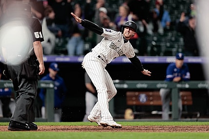 Jun 1, 2021; Denver, Colorado, USA; Colorado Rockies second baseman Ryan McMahon (24) reacts after reaching home on a play in the eleventh inning against the Texas Rangers at Coors Field. Mandatory Credit: Isaiah J. Downing-USA TODAY Sports