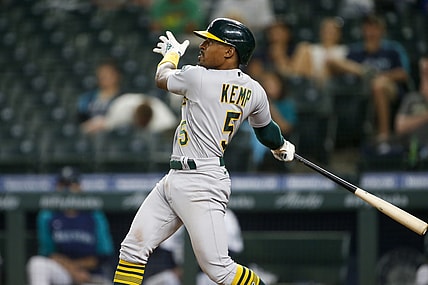 Jun 1, 2021; Seattle, Washington, USA; Oakland Athletics second baseman Tony Kemp (5) hits an RBI-sacrifice fly against the Seattle Mariners during the seventh inning at T-Mobile Park. Mandatory Credit: Joe Nicholson-USA TODAY Sports