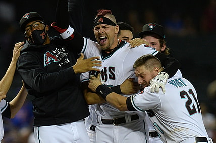 Jun 1, 2021; Phoenix, Arizona, USA; Arizona Diamondbacks right fielder Josh Reddick (22) celebrates with teammates after his walk off two run RBI hit against the New York Mets during the tenth inning at Chase Field. Mandatory Credit: Joe Camporeale-USA TODAY Sports