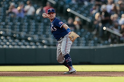 Jun 2, 2021; Denver, Colorado, USA; Texas Rangers third baseman Brock Holt (16) makes a throw to first for an out in the first inning against the Colorado Rockies at Coors Field. Mandatory Credit: Isaiah J. Downing-USA TODAY Sports