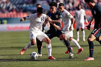 Jun 3, 2021; Denver, Colorado, USA; Honduras midfielder Jonathan Rubio (17) and United States midfielder Weston Mckennie (8) battle for the ball in the first half during the semifinals of the 2021 CONCACAF Nations League soccer series at Empower Field at Mile High. Mandatory Credit: Isaiah J. Downing-USA TODAY Sports