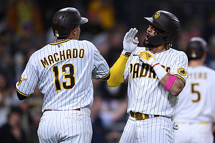 Jun 3, 2021; San Diego, California, USA; San Diego Padres shortstop Fernando Tatis Jr. (right) celebrates with  third baseman Manny Machado (13) after hitting a two-run home run against the New York Mets during the third inning at Petco Park. Mandatory Credit: Orlando Ramirez-USA TODAY Sports