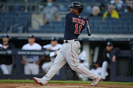 Jun 4, 2021; Bronx, New York, USA; Boston Red Sox third baseman Rafael Devers (11) follows through on a three run home run against the New York Yankees during the first inning at Yankee Stadium. Mandatory Credit: Brad Penner-USA TODAY Sports