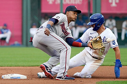 Jun 4, 2021; Kansas City, Missouri, USA; Minnesota Twins shortstop Jorge Polanco (11) can   t make the tag as Kansas City Royals second baseman Whit Merrifield (15) steals second base in the first inning at Kauffman Stadium. Mandatory Credit: Denny Medley-USA TODAY Sports