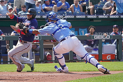 Jun 5, 2021; Kansas City, Missouri, USA; Kansas City Royals catcher Salvador Perez (13) tags out Minnesota Twins designated hitter Nelson Cruz (23) as he tries to score in the third inning at Kauffman Stadium. Mandatory Credit: Denny Medley-USA TODAY Sports