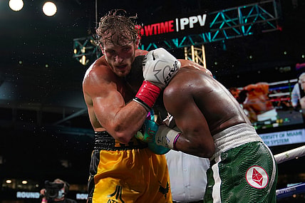 Jun 6, 2021; Miami, Florida, USA; Floyd Mayweather Jr. (Green Trunks) fights Logan Paul (Yellow Trunks) during an exhibition boxing match at Hard Rock Stadium. Mandatory Credit: Jasen Vinlove-USA TODAY Sports