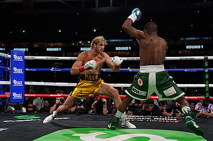Jun 6, 2021; Miami, Florida, USA; Floyd Mayweather Jr. (Green Trunks) fights Logan Paul (Yellow Trunks) during an exhibition boxing match at Hard Rock Stadium. Mandatory Credit: Jasen Vinlove-USA TODAY Sports