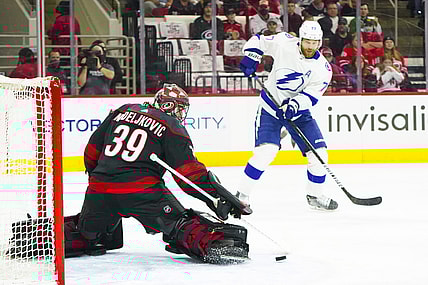 Jun 8, 2021; Raleigh, North Carolina, USA; Carolina Hurricanes goaltender Alex Nedeljkovic (39) makes a first period save against Tampa Bay Lightning defenseman Victor Hedman (77) in game five of the second round of the 2021 Stanley Cup Playoffs at PNC Arena. Mandatory Credit: James Guillory-USA TODAY Sports