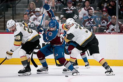 Jun 8, 2021; Denver, Colorado, USA; Colorado Avalanche center Pierre-Edouard Bellemare (41) battles for control of the puck with Vegas Golden Knights defenseman Peter DiLiberatore (3) and left wing William Carrier (28) in the first period in game five of the second round of the 2021 Stanley Cup Playoffs at Ball Arena. Mandatory Credit: Isaiah J. Downing-USA TODAY Sports