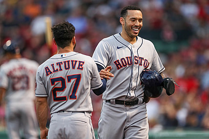 Jun 9, 2021; Boston, Massachusetts, USA; Houston Astros shortstop Carlos Correa (1) and second baseman Jose Altuve (27) react after Correa scored during the third inning against the Boston Red Sox at Fenway Park. Mandatory Credit: Paul Rutherford-USA TODAY Sports