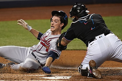 Jun 12, 2021; Miami, Florida, USA; Miami Marlins catcher Sandy Leon (7) tags out Atlanta Braves starting pitcher Max Fried (54) at the plate in the 3rd inning at loanDepot park. Mandatory Credit: Jasen Vinlove-USA TODAY Sports