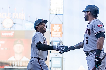 Jun 15, 2021; San Francisco, California, USA; Arizona Diamondbacks center fielder Ketel Marte (4) celebrates with left fielder David Peralta (6) after scoring against the San Francisco Giants in the second inning at Oracle Park. Mandatory Credit: John Hefti-USA TODAY Sports
