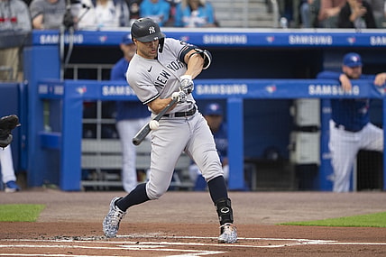 Jun 16, 2021; Buffalo, New York, CAN; New York Yankees designated hitter Giancarlo Stanton (27) hits a sacrifice fly to drive in a run during the first inning against the Toronto Blue Jays at Sahlen Field. Mandatory Credit: Gregory Fisher-USA TODAY Sports