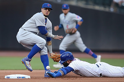 Jun 16, 2021; New York City, New York, USA; New York Mets third baseman Jonathan Villar (1) steals second base as Chicago Cubs shortstop Javier Baez (9) can't handle the throw during the first inning at Citi Field. Mandatory Credit: Brad Penner-USA TODAY Sports