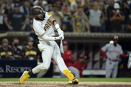 Jun 18, 2021; San Diego, California, USA;  San Diego Padres shortstop Fernando Tatis Jr. (23) hits a single against the Cincinnati Reds in the fourth inning at Petco Park. Mandatory Credit: Ray Acevedo-USA TODAY Sports