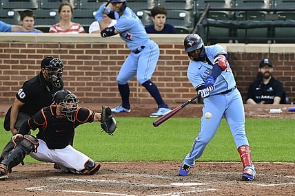 Jun 19, 2021; Baltimore, Maryland, USA;  Toronto Blue Jays designated hitter Vladimir Guerrero Jr. (27) hits as rbi double in the ninth inning against the Baltimore Orioles at Oriole Park at Camden Yards. Mandatory Credit: Tommy Gilligan-USA TODAY Sports