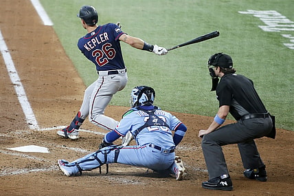 Jun 20, 2021; Arlington, Texas, USA; Minnesota Twins right fielder Max Kepler (26) follows through on a swing for a two-run single in the third inning against the Texas Rangers at Globe Life Field. Mandatory Credit: Tim Heitman-USA TODAY Sports