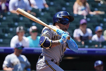 Jun 20, 2021; Denver, Colorado, USA; Milwaukee Brewers second baseman Kolten Wong (16) singles in the first inning against the Colorado Rockies at Coors Field. Mandatory Credit: Ron Chenoy-USA TODAY Sports