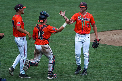 Jun 20, 2021; Omaha, Nebraska, USA; Virginia Cavaliers pitcher Matt Wyatt (15) celebrates the win with catcher Logan Michaels (12) against the Tennessee Volunteers at TD Ameritrade Park. Mandatory Credit: Steven Branscombe-USA TODAY Sports