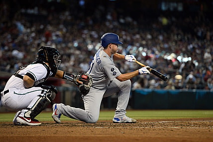 Jun 20, 2021; Phoenix, Arizona, USA; Los Angeles Dodgers relief pitcher Garrett Cleavinger puts down a fielder's choice RBI bunt against the Arizona Diamondbacks during the fifth inning at Chase Field. Mandatory Credit: Joe Camporeale-USA TODAY Sports
