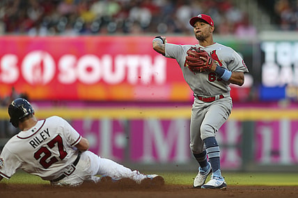Jun 20, 2021; Atlanta, Georgia, USA; St. Louis Cardinals shortstop Edmundo Sosa (63) turns a double play over Atlanta Braves third baseman Austin Riley (27) in the fourth inning at Truist Park. Mandatory Credit: Brett Davis-USA TODAY Sports