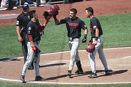 Jun 21, 2021; Omaha, Nebraska, USA;  Stanford Cardinal outfielder Brock Jones (7) celebrates a home run with outfielder Eddie Park (14) and infielder Adam Crampton (10) against the Arizona Wildcats in the seventh inning at TD Ameritrade Park. Mandatory Credit: Steven Branscombe-USA TODAY Sports