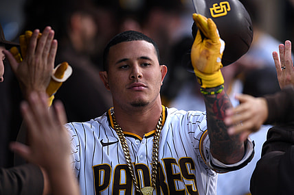 Jun 21, 2021; San Diego, California, USA; San Diego Padres third baseman Manny Machado (13) is congratulated in the dugout after hitting a three-run home run during the first inning against the Los Angeles Dodgers at Petco Park. Mandatory Credit: Orlando Ramirez-USA TODAY Sports