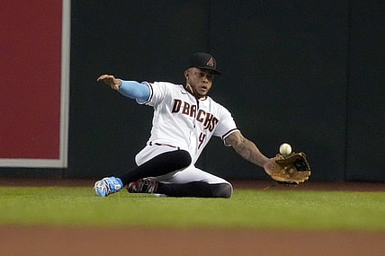 Jun 21, 2021; Phoenix, Arizona, USA; Arizona Diamondbacks second baseman Ketel Marte (4) makes the sliding catch for an out against the Milwaukee Brewers in the fourth inning at Chase Field. Mandatory Credit: Rick Scuteri-USA TODAY Sports